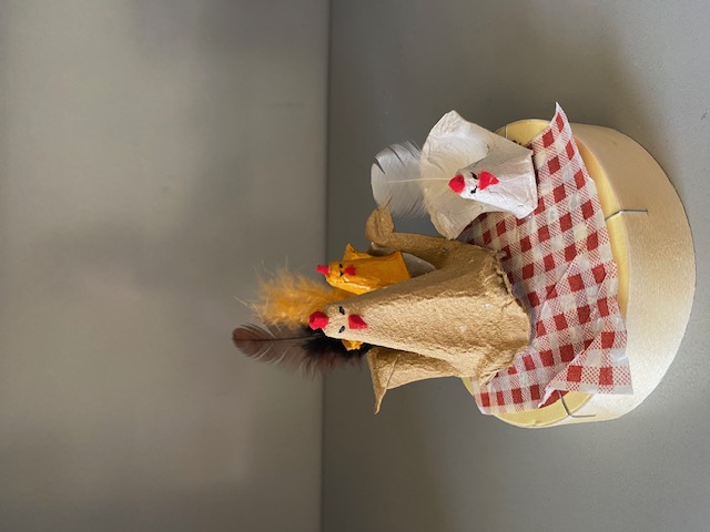 photographie d'une "petite poulette" sur une boite à camembert retournée